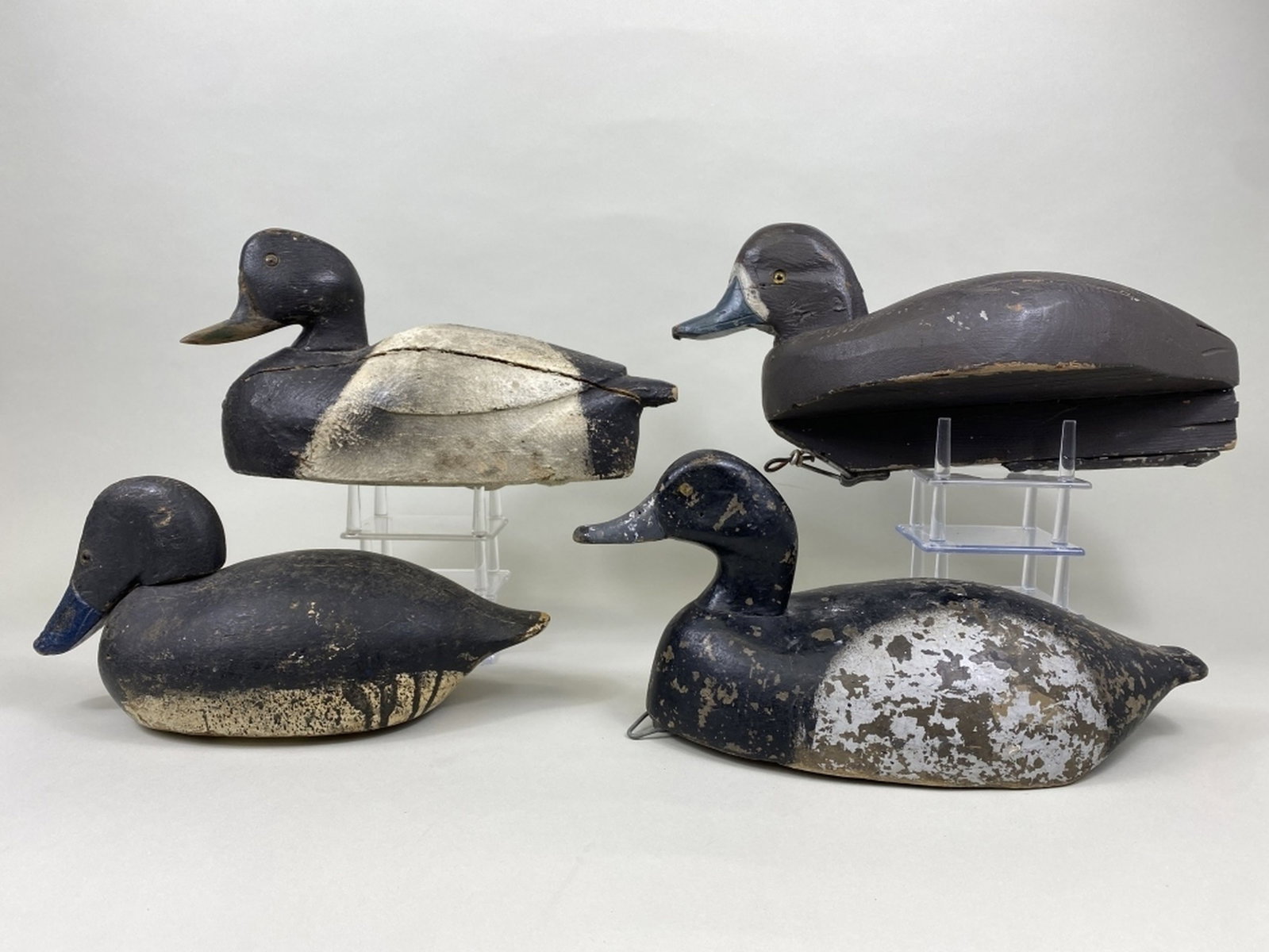 4 Bluebill Duck Decoys: all have solid bodies & repainted, 3 glass eyes, 1 painted eyes, 1 Michigan, 3 Wisconsin, paint flaking, bill repairs, shot marks, paint loss on all, moderate gunning wear, Terry Smart Collection, siz