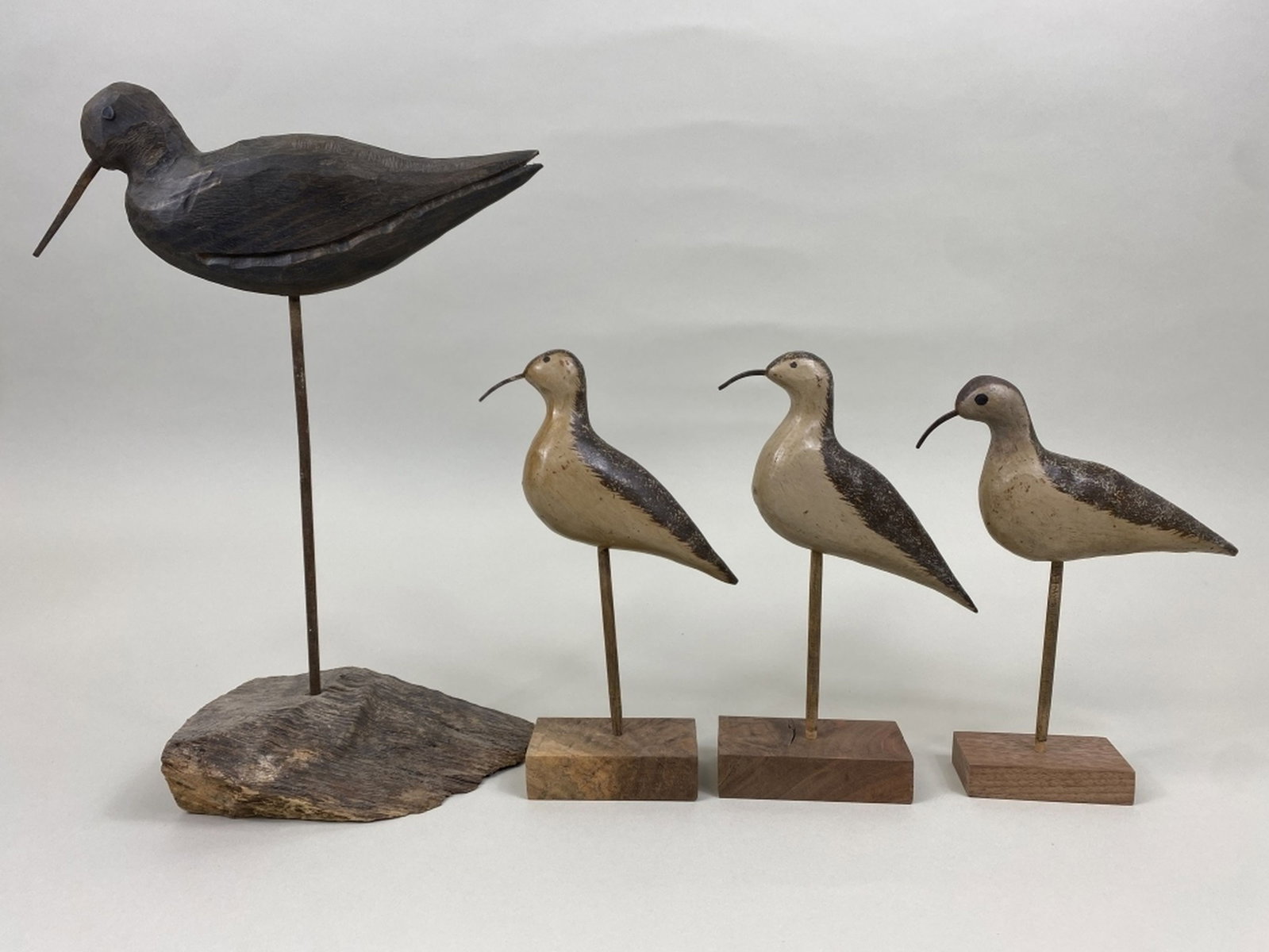 4 Shorebirds: by unknown carvers, 3 have painted eyes, metal bills, appears to be original paint, "H" brands on bottom, drilled holes in tail for carrying purposes & 1 with nail eyes, iron bill, distressed wear, st