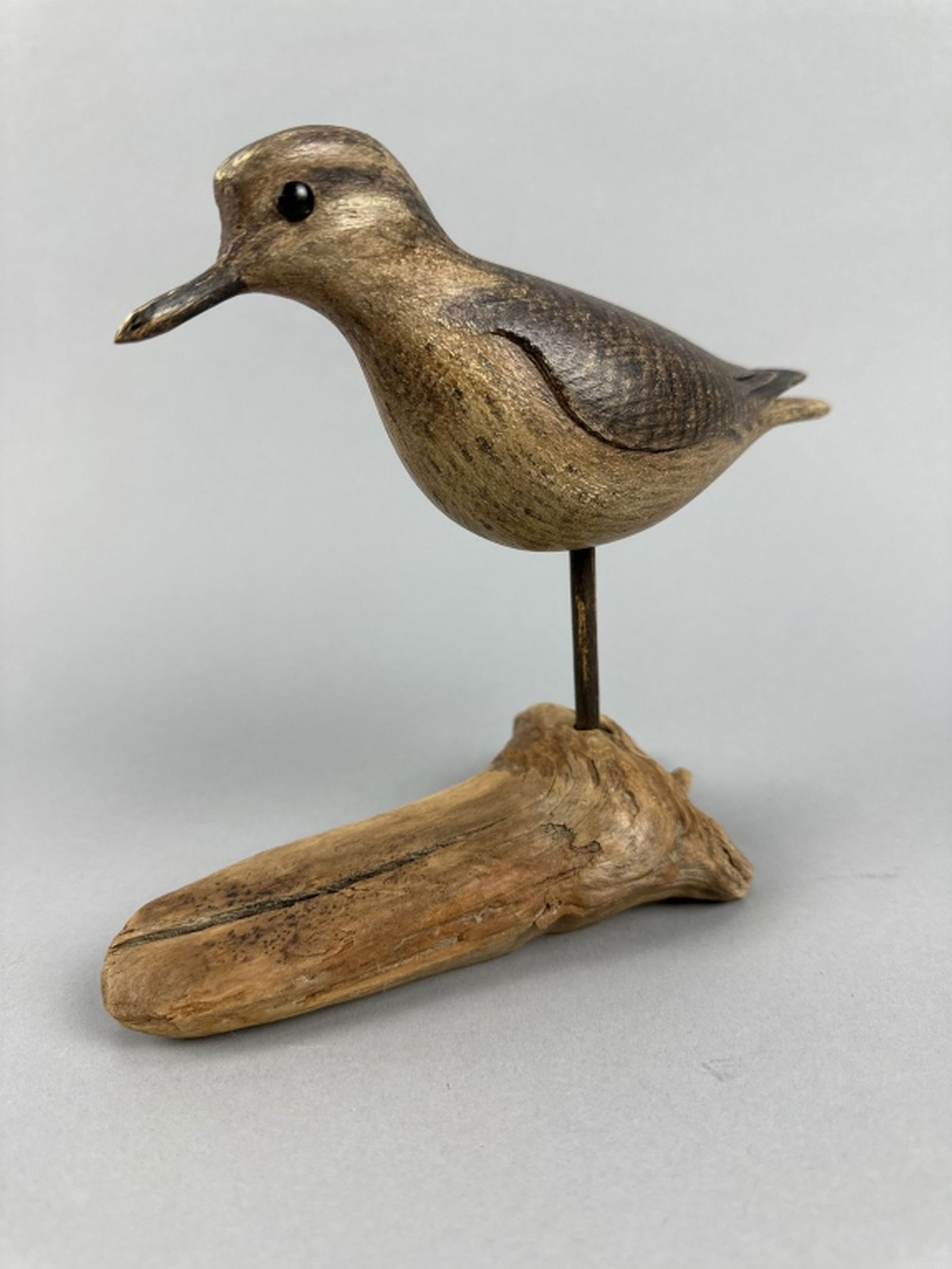 David Ward Sandpiper Shorebird: Essex, CT, glass eyes, strong original paint with distressed wear, great form with relief carved wing detail, comes with driftwood stand, makers initials on bottom, Roger Ludwig Collection, 7.5"L, est