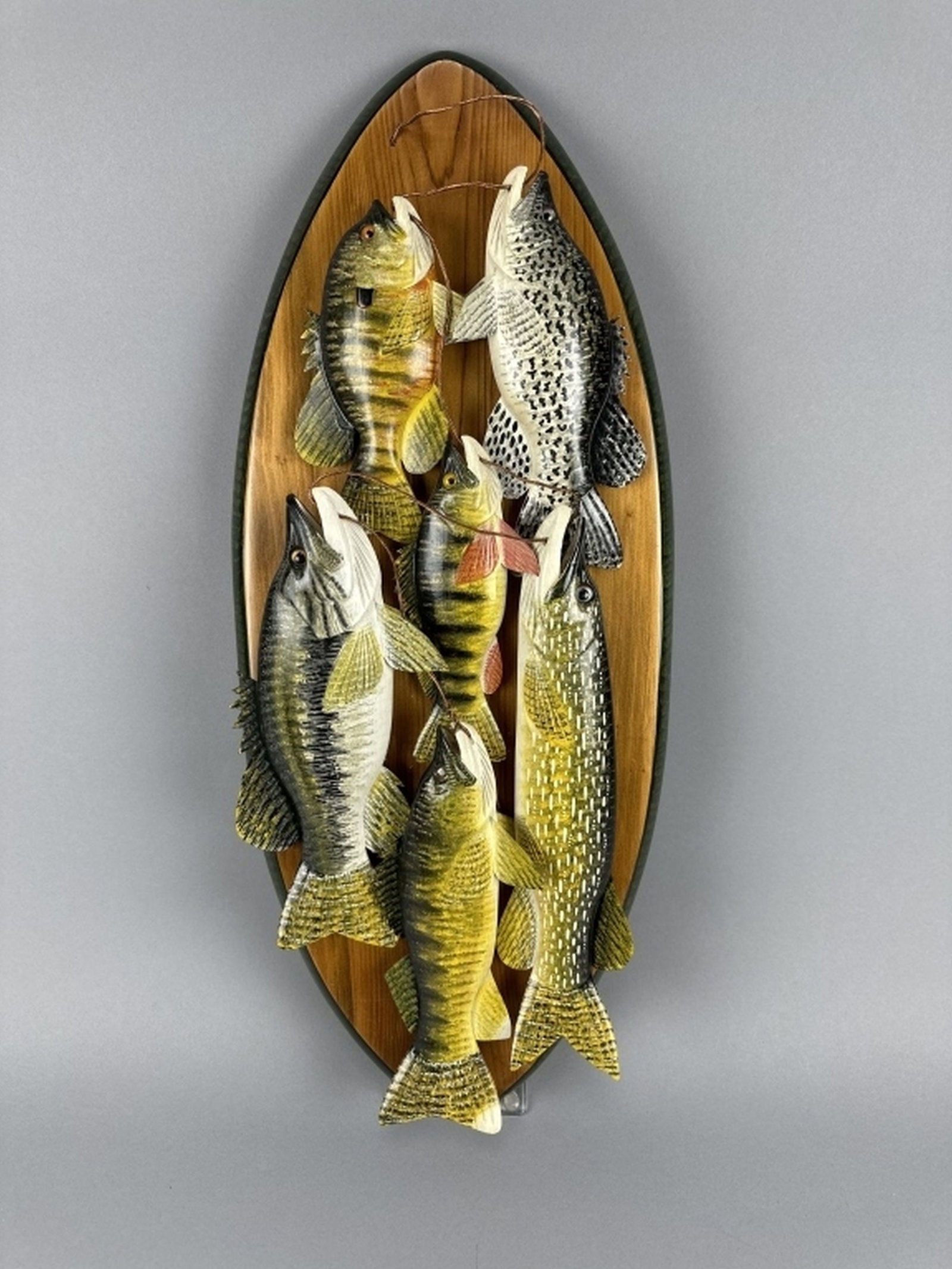 Carl Christiansen Fish Plaque: Newberry, MI, features 6 fish with stringer mounted on plaque, 1 bluegill, 1 crappie, 1 perch, 1 bass, 1 northern pike & 1 walleye, all are in excellent condition, makers signature on back of plaque, 