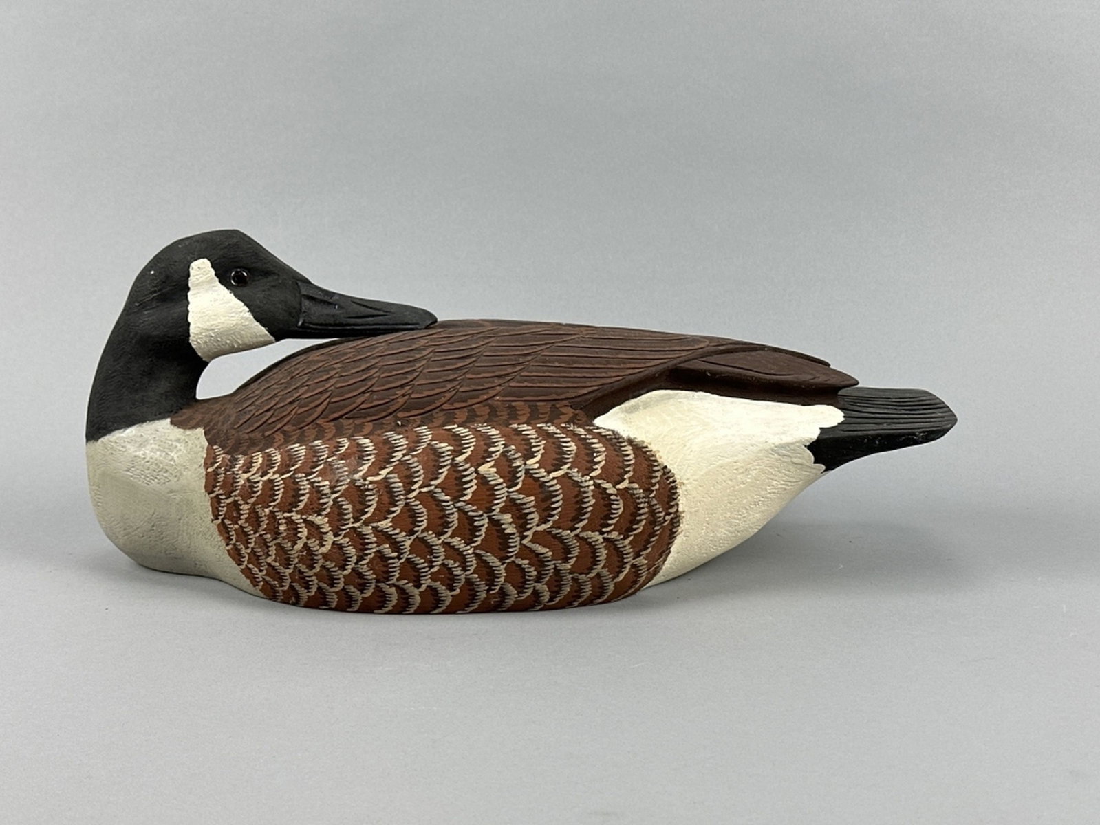 Ralph Malpage Canada Goose Decoy: London, ONT, glass eyes, hollow body, excellent original paint, nice form in preening position, makers signature on bottom, 18"L, est. 200 - 400