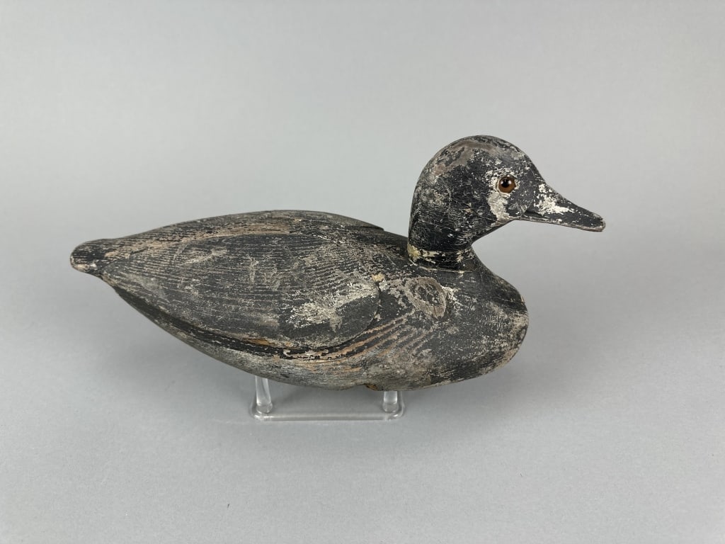 William Bell Bluebill Drake Duck Decoy: Oshawa, ONT, glass eyes, solid body, worn original paint, a few shot marks & some age cracks in bottom, wood knot on right side, 13.5"L, est. 300 - 500