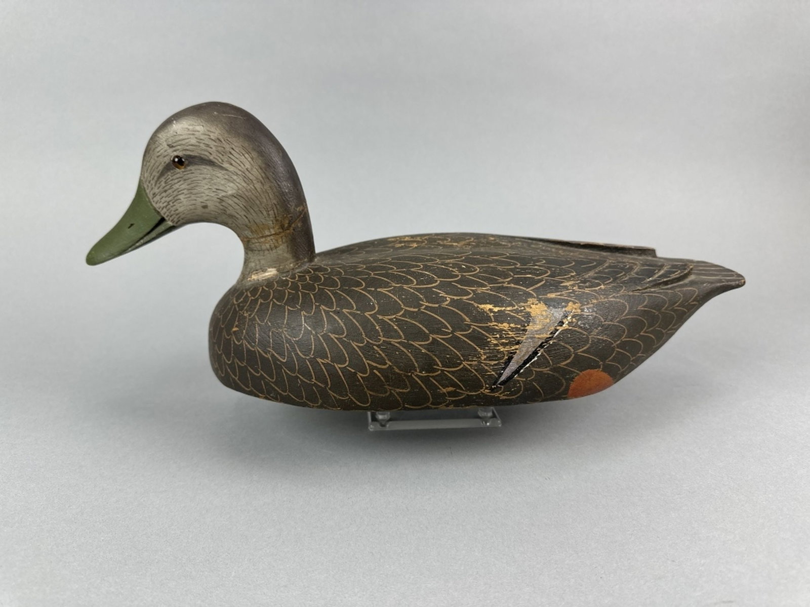Davey Nichol Black Duck Decoy: Smiths Falls, ONT, glass eyes, solid body, original paint with some flaking & wear, age crack through neck that has been reset, relief wing carving, 17"L, est. 400 - 700