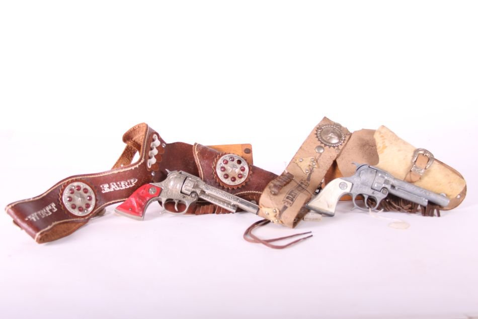 Pr. Of Hubley Texan Jr. Cap Guns, Die Cast, One w/ Red: Pr. Of Hubley Texan Jr. Cap Guns, Die Cast, One w/ Red Steer Head Grip, One w/ White Steer Head Grip, w/ Davey Crocket Holster and Belt by S. Hastings, and Wyatt Earp Holster and Belt