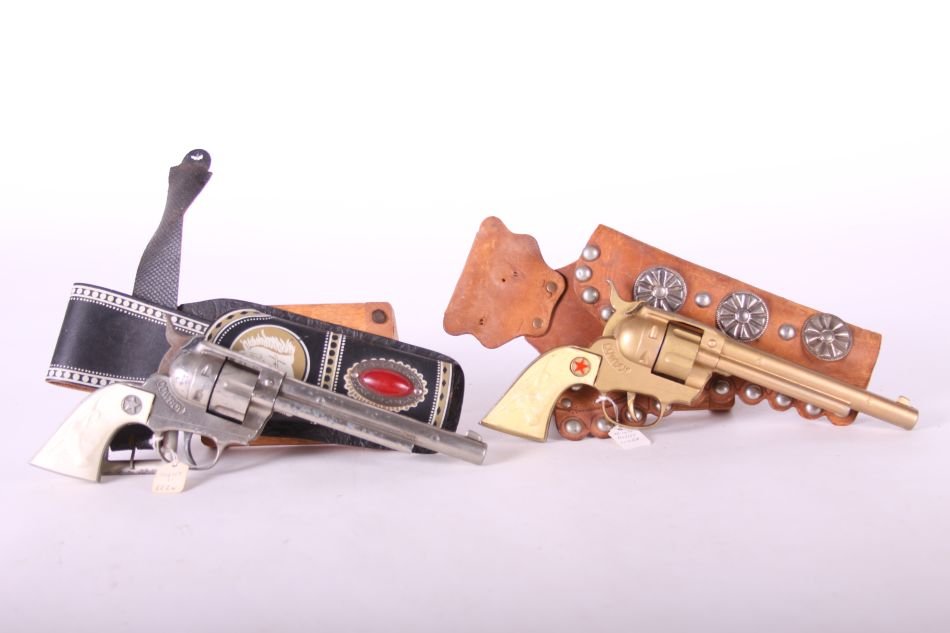 Pr. Of Hubley, Cowboy Cap Guns, Die Cast, One w/ White: Pr. Of Hubley, Cowboy Cap Guns, Die Cast, One w/ White Steer Head Grips, One w/ Yellowed Steer Head Grips, w/ One Black Holster and Belt, One Brown Holster and Belt