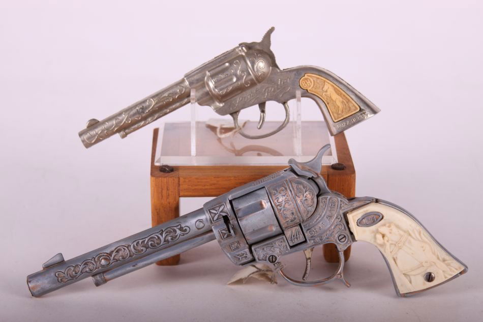 Lot of Two Cap Guns, One Leslie Henry, Gene Autry .44,: Lot of Two Cap Guns, One Leslie Henry, Gene Autry .44, w/ White Horsehead Handles, Die-cast, One Buzz Henry, Lone Rider, w/ Yellowed Horse Grips, Die-Cast