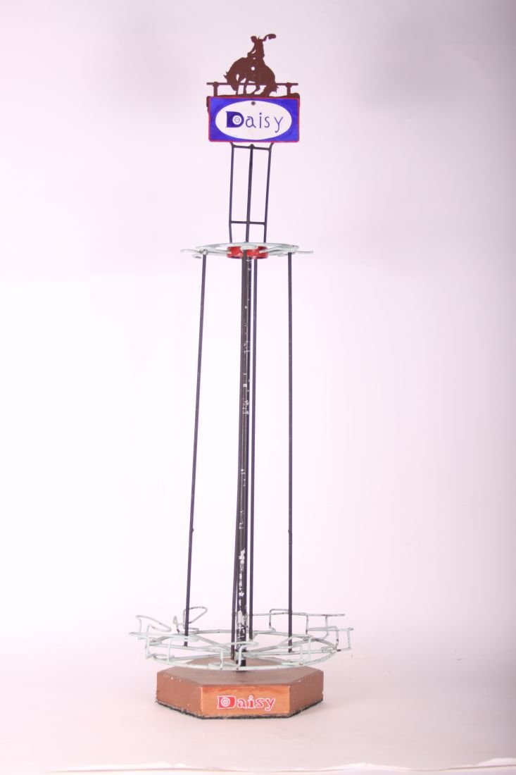 Daisy Metal Rotating Gun Rack, 8 Gun Slots, 45" high,: Daisy Metal Rotating Gun Rack, 8 Gun Slots, 45" high, 14" wide, Daisy Sign & Bucking Bronco on Top, Cement Base