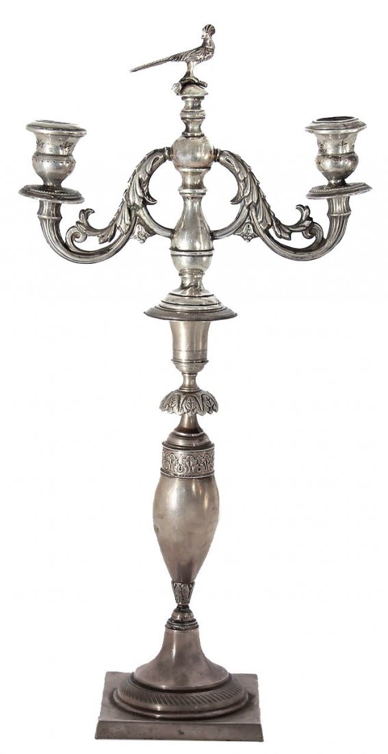 Silver candleholders. Europe. Start of 20th century.: Floral embossing with a bird on the upper portion. Comes apart into two pieces. Height: 49.5cm. Weight: 718g.