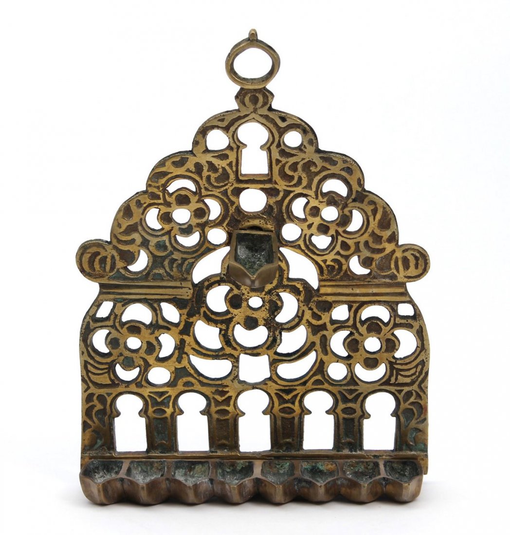 Nice copper hanukkiyah. Morocco, start of the 20th: Engraving work. Decorated with cutting of windows and flowers. 23cm high.