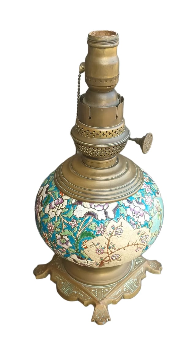 Longwy Lamp Base: Cast brass lamp base with a globe-form Longwy tile that measures 7.5"dia…the paddle-footed base is 6” x 6”…height is 14”…originally an oil lamp, now electrified; th