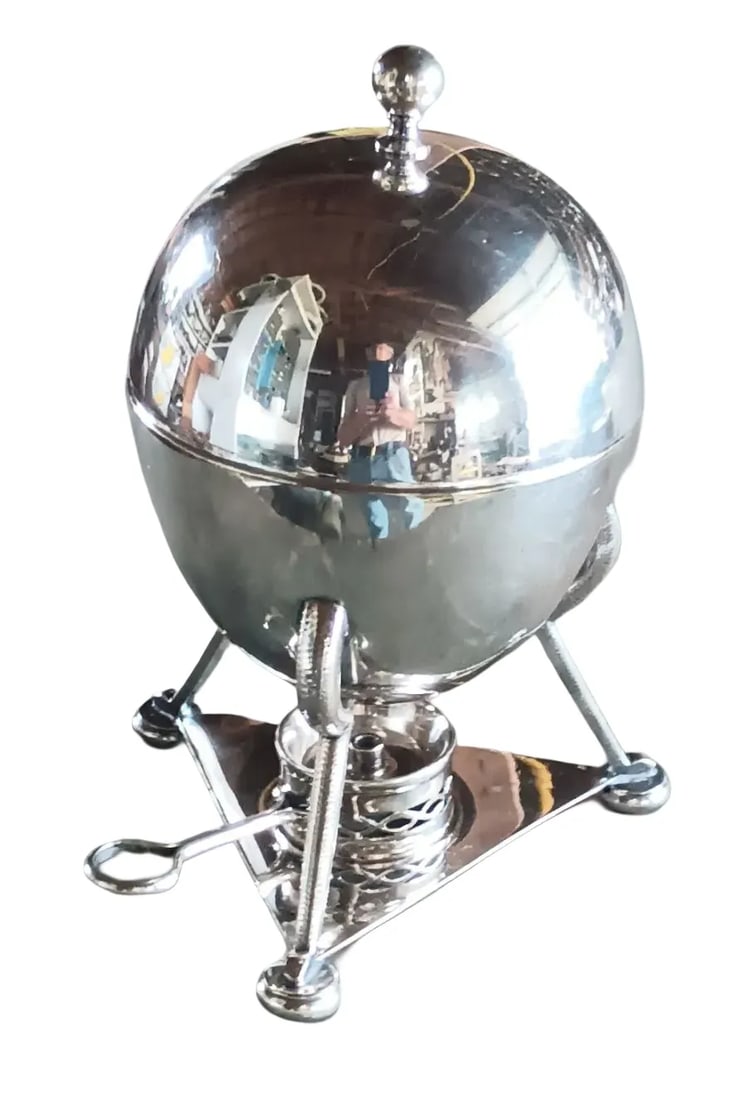 Wm. Hutton & Sons Silver Plate Egg Coddler: A charming silver plate egg form on bird legs standing on button feet and supporting a tray which holds a small spirit burner to keep your four eggs warm inside. Excellent condition and signed on the