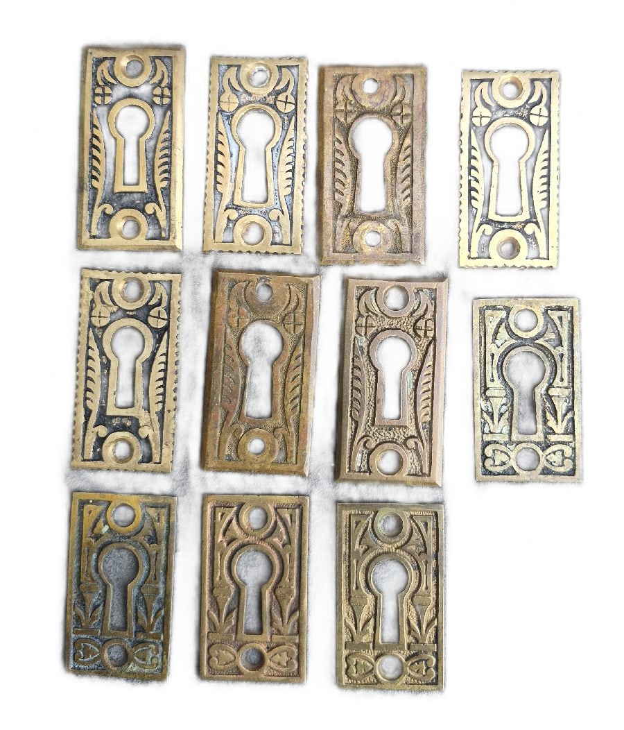 Keyhole Escutcheons: 11 brass keyhole escutcheons 2" x 1"...good as found