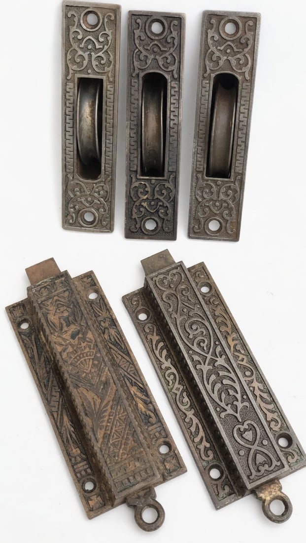 Jamb Bolts & Sash Pullys: Two cast iron jamb bolts and three cast iron sash pullys...all with nice decoration and working...pullys are 4.5" x 2" and the jamb bolts are 5: x 2.5"....good as found