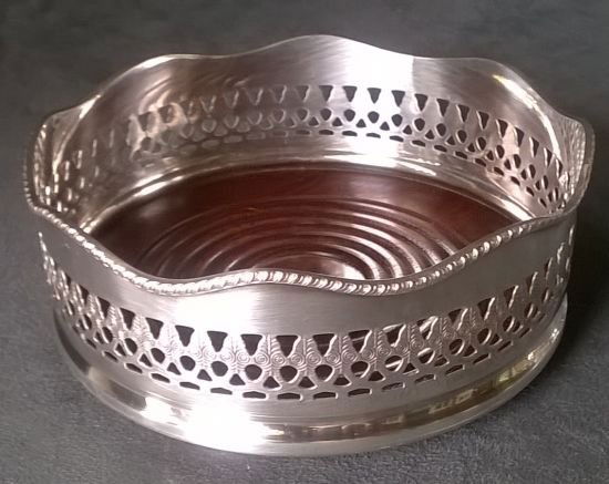 Large Silver Plate Wine Coaster: Nice large SP wine coaster, 2” high and 5” diameter, with strongly reticulated sides and gadrooned bands around both the top and base. Unmarked. Very good condition.