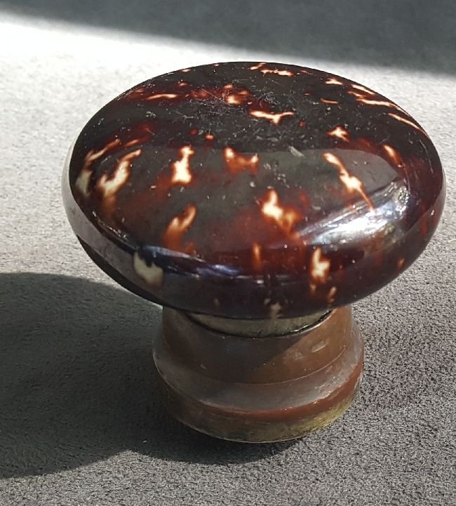 Entry Size Knob With Rockingham Glaze: Mushroom form ceramic entry knob decorated with a Rockingham glaze…based in a tapered brass shank…American from the mid-19th Century…excellent condition…