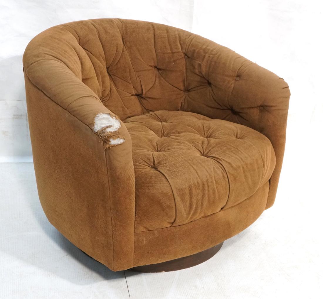 MILO BAUGHMAN Modernist Swivel Lounge Chair. Roun: MILO BAUGHMAN Modernist Swivel Lounge Chair. Round walnut skirted base. Tufted brown upholstery. Unmarked-- Dimensions: H: 26 inches: W: 30 inches: D: 31.5 inches ---