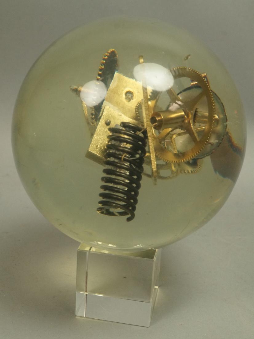 Lucite Acrylic Sphere with internal Clock Parts.: Lucite Acrylic Sphere with internal Clock Parts. Glass cube base.-- Dimensions: H: 7 inches: W: 5 inches: D: 5 inches --- US Shipping charge: $35