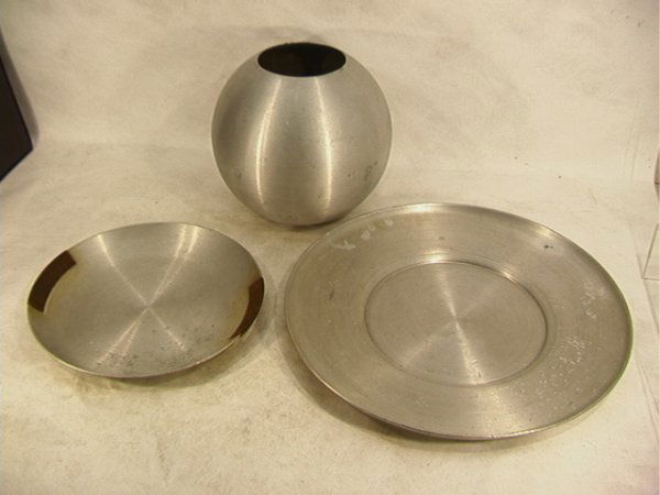 3 PC RUSSEL WRIGHT Spun Aluminum Serving Piece. Lot: 3 PC RUSSEL WRIGHT Spun Aluminum Serving Piece. Lot includes large spun aluminum spherical vase; Serving Tray with rattan wrapped handles; and very large serving tray. Vase and handled tray are marked