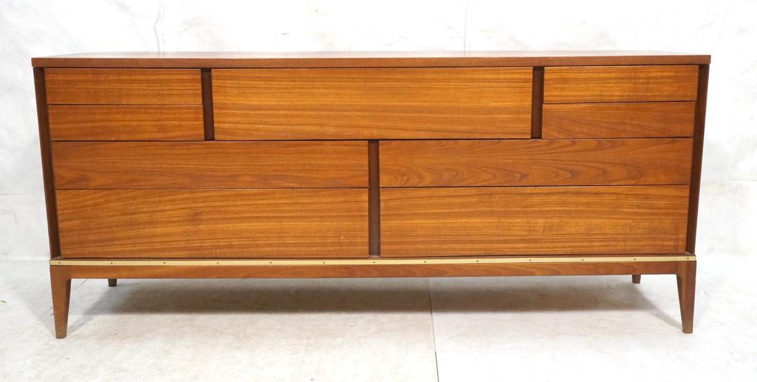 American Modern Walnut Credenza. 9 drawers. Trim: American Modern Walnut Credenza. 9 drawers. Trim band to skirt. Raised on tapered legs.-- Dimensions: H: 32 inches: W: 73.5 inches: D: 19 inches ---