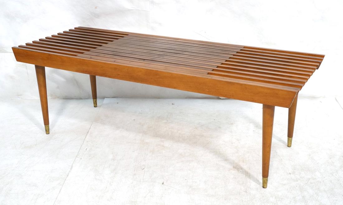 Extension Modern Wood Slat Table. Beveled ends to: Extension Modern Wood Slat Table. Beveled ends to slats. Tall elegant tapered peg legs with metal caps. Table extends in length to 64".-- Dimensions: H: 15 inches: W: 48 inches: D: 18 inches ---