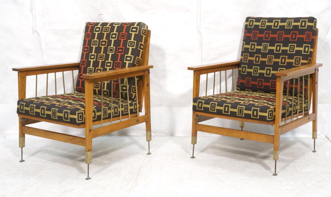Pr Mid Century Lounge Chairs. Brass rods under ar: Pr Mid Century Lounge Chairs. Brass rods under arm details. Wood slat back. Black, Fabric cushions with red and olive pattern details. Each leg is raised on welded metal risers. -- Dimensions: H: 33 i