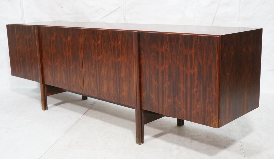 Modernist Rosewood 4 Door Credenza Sideboard. Sty: Modernist Rosewood 4 Door Credenza Sideboard. Stylish shaped legs continue to form door handles. One cabinet with interior drawers. Not marked.-- Dimensions: H: 29.5 inches: W: 90.75 inches: D: 20.5 i