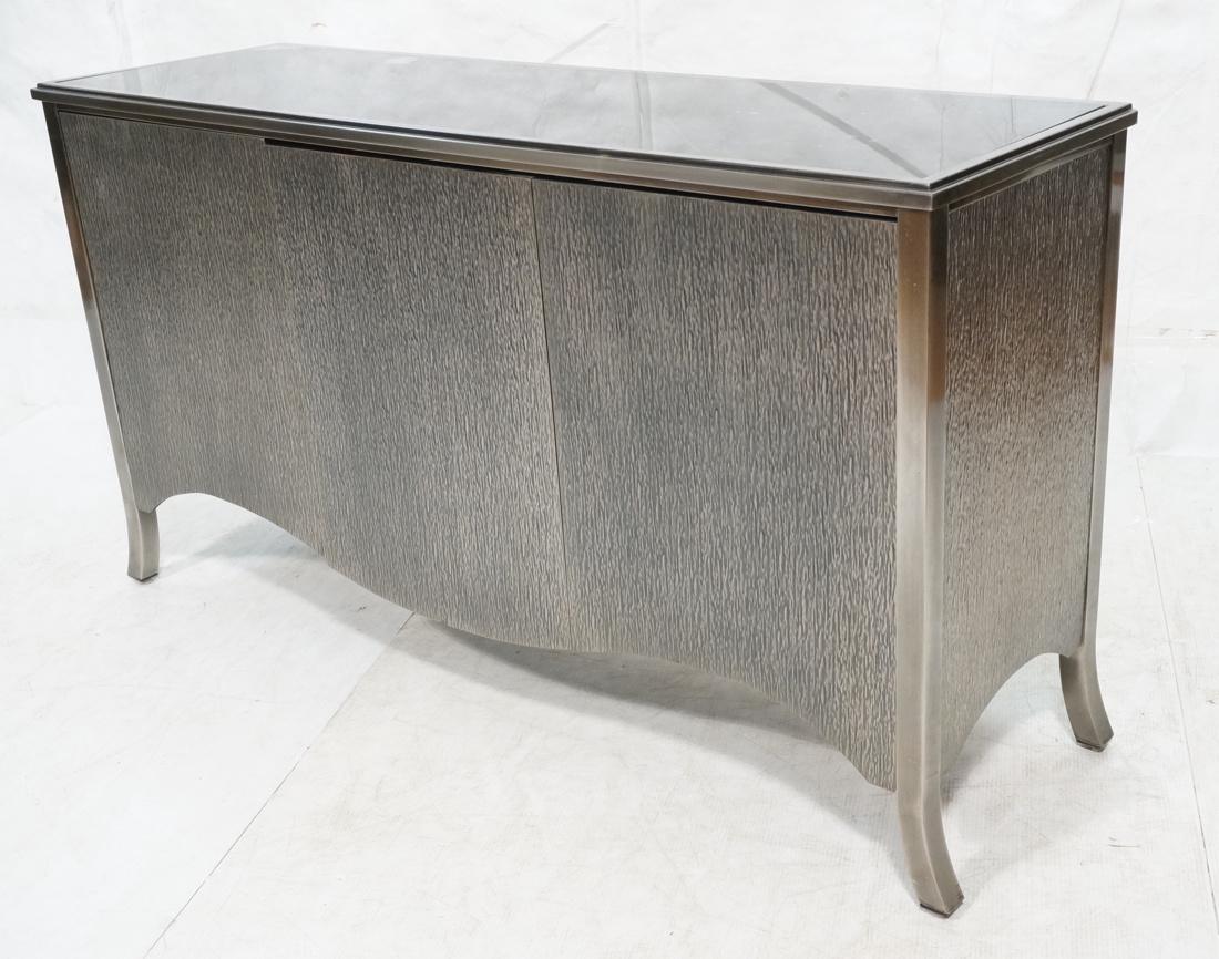 3 Door Stainless Modern Credenza Sideboard. Bark: 3 Door Stainless Modern Credenza Sideboard. Bark textured stainless door and side panels. Glass top with black finish. Stainless frame & curved legs.-- Dimensions: H: 34.5 inches: W: 62.5 inches: D: 1