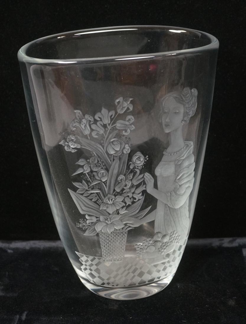 HADELAND Swedish Lg Art Glass Vase Etched Design: HADELAND Swedish Lg Art Glass Vase Etched Design of Woman in pearls, flower bouquet and fruit bowl. Elaborately detailed. Clear glass. Engraved Hadeland BM-- Dimensions: H: 10.25 inches: W: 7.5 inches