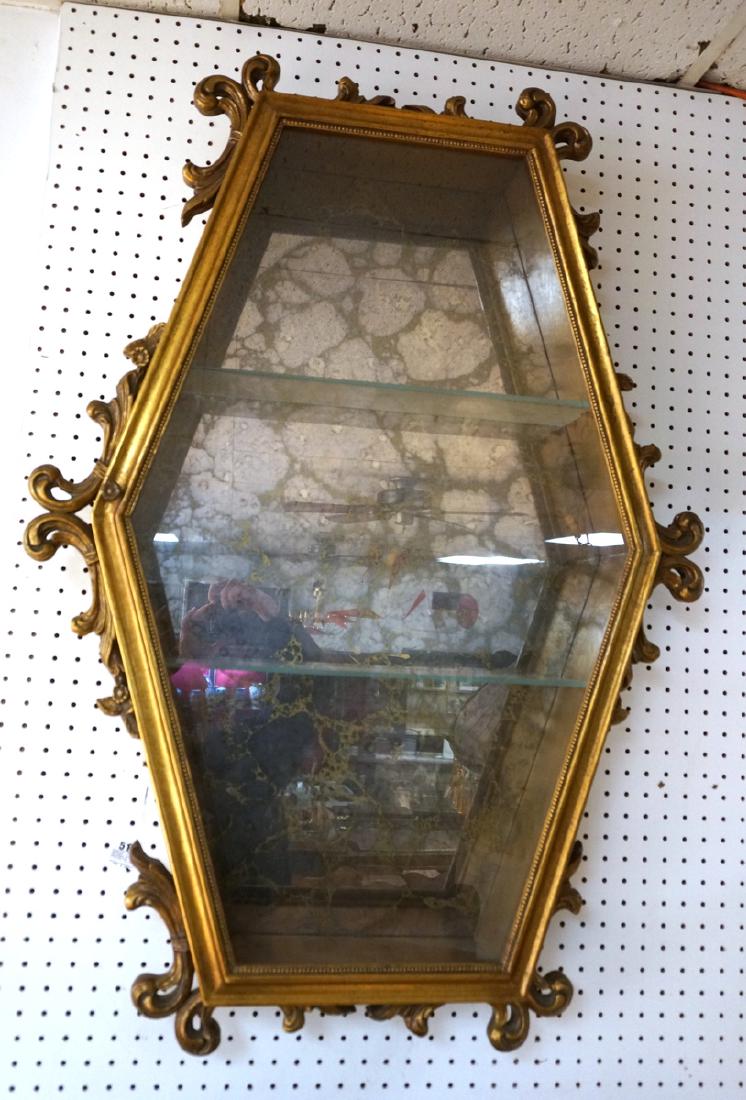 Hexagonal Gilt Wood Framed Display Cabinet. Antiq: Hexagonal Gilt Wood Framed Display Cabinet. Antiqued mirrored back, interior glass shelves. Fancy scrolled decoration.-- Dimensions: H: 43 inches: W: 29.5 inches: D: 5.5 inches ---