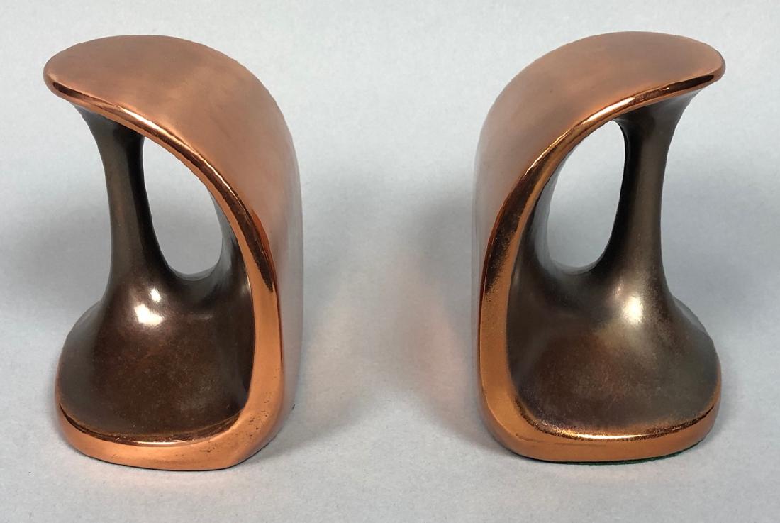 Pr Copper tone BEN SEIBERT Modernist Bookends. Sh: Pr Copper tone BEN SEIBERT Modernist Bookends. Shiny copper finish on stirrup form. JENFRED-WARE for RAYMOR label.-- Dimensions: H: 5 inches: W: 5.25 inches: D: 3.5 inches --- US Shipping charge: $35