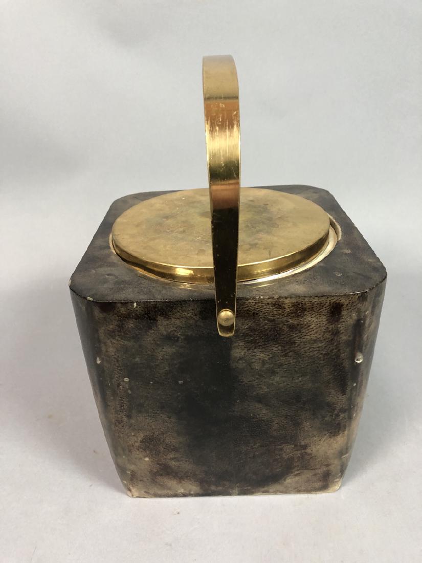 ALDO TURA Lacquered Goatskin Square Ice Bucket. B: ALDO TURA Lacquered Goatskin Square Ice Bucket. Brown goatskin bucket with brass tone handle. Interior insulated glass liner. Not marked.-- Dimensions: H: 13 inches: W: 8.5 inches: D: 8.5 inches ---