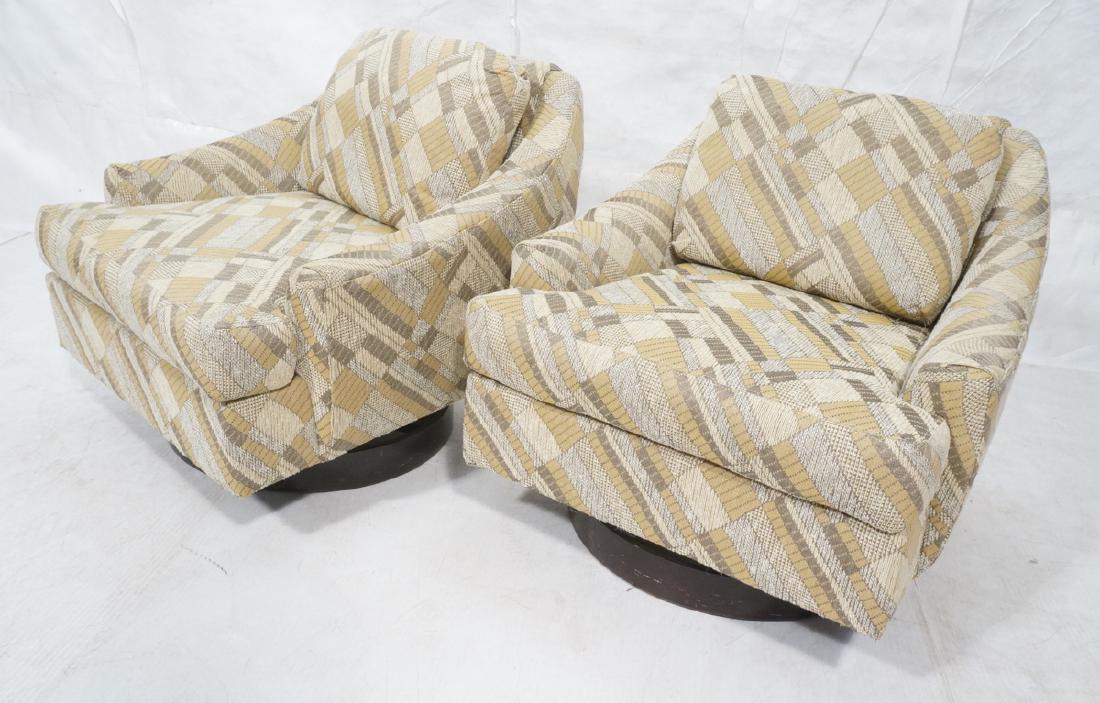 Pr SELIG Modern Swivel Lounge Chairs. Sloped arm: Pr SELIG Modern Swivel Lounge Chairs. Sloped arm upholstered chairs. Swivel on ebonized wood drum base. Patterned beige, brown, tan fabric. Fabric Selig tag.-- Dimensions: H: 29.5 inches: W: 31.5 inch