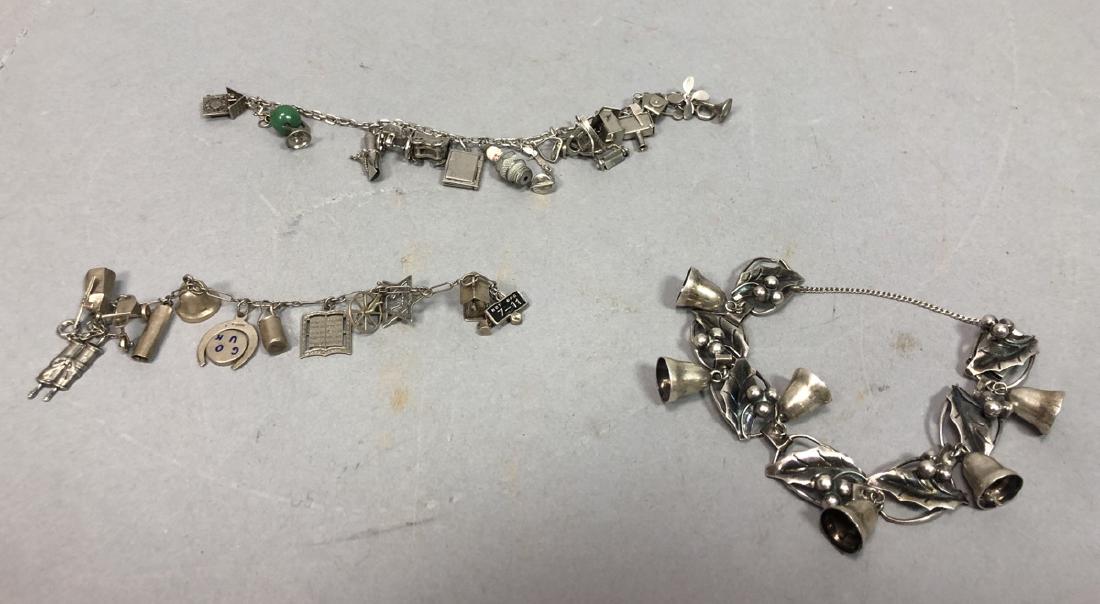 3 Sterling Silver Charm Bracelets. 1) Taxco Mexic: 3 Sterling Silver Charm Bracelets. 1) Taxco Mexican sterling with holly leaves and bells, marked. 2) 14 charm bracelet with world globe, clock and other mechanical charms. 3) 6" child's charm bracelet