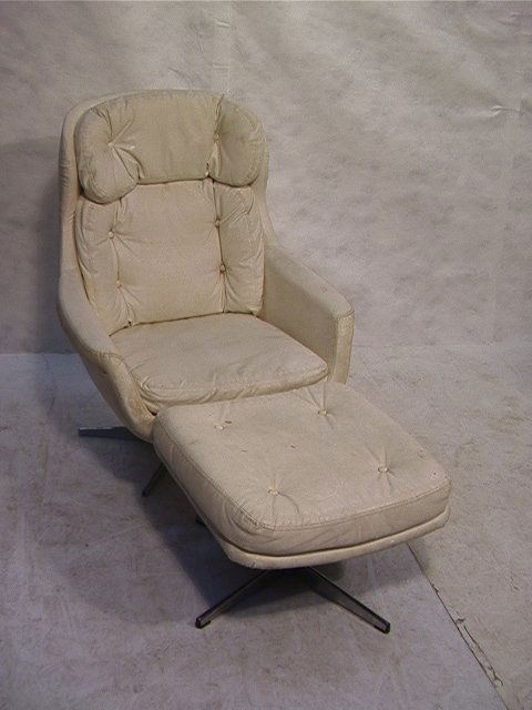 Selig White Vinyl Egg Style Chair and Ottoman. C: Selig White Vinyl Egg Style Chair and Ottoman. Chrome base. Unmarked. Dimensions: H: 40.5 inches: W: 21 inches: L: 31 inches Condition: Vinyl needs some cleaning. Hole in ottoman. Crack to vinyl on on