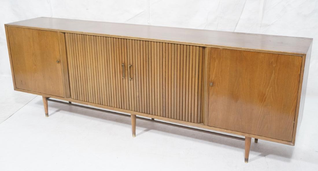 8' American Modern Walnut Credenza. Center slidin: 8' American Modern Walnut Credenza. Center sliding tambour doors. 2 swing out doors. Tapered wood legs brass caps. Metal pulls.-- Dimensions: H: 32.5 inches: W: 96 inches: D: 18.25 inches ---