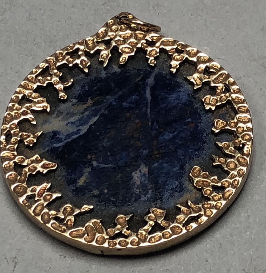 9K Gold Sodalite Round Pendant. Probably English.: 9K Gold Sodalite Round Pendant. Probably English. Brutalist modern gold trim. Bale is marked 9K.-- Dimensions: H: 2 inches: W: 1.75 inches --- US Shipping charge: $10