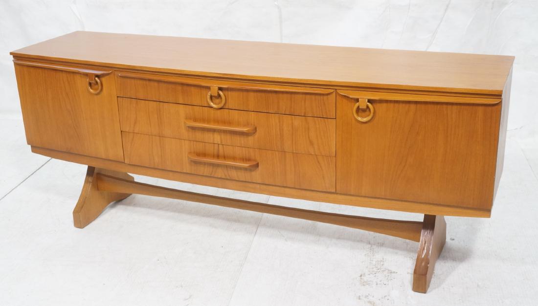 English Modern Teak Credenza on Trestle Base. 2 c: English Modern Teak Credenza on Trestle Base. 2 cabinets 3 drawers. O ring pulls.-- Dimensions: H: 29 inches: W: 72.5 inches: D: 19 inches ---