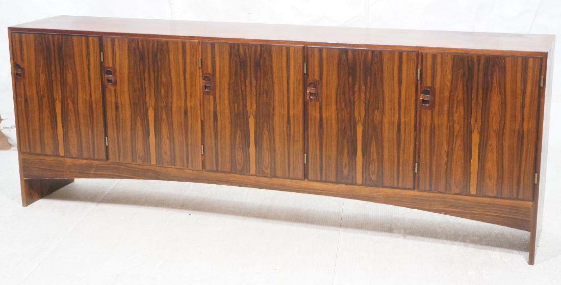 Danish Modern Rosewood Tall Credenza. Arched skir: Danish Modern Rosewood Tall Credenza. Arched skirt. Recessed handles with locking latch. Brass hinges.-- Dimensions: H: 35.5 inches: W: 97.5 inches: D: 18 inches ---