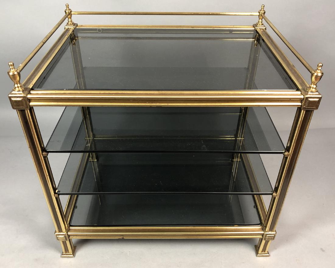 Small Decorator Brass Glass Shelf Unit. Gallery t: Small Decorator Brass Glass Shelf Unit. Gallery top with urn finials. Smoked glass shelves. Heavy Construction.-- Dimensions: H: 17 inches: W: 18 inches: D: 13 inches ---