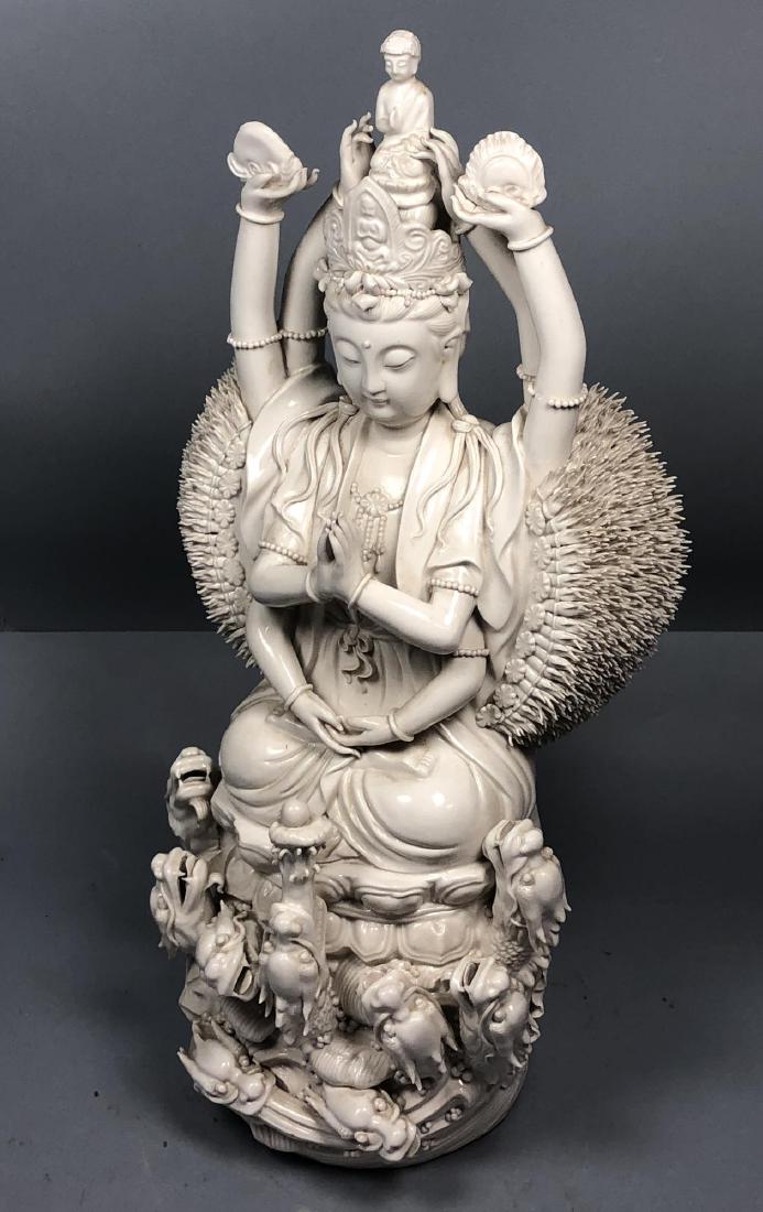 Large Asian Blanc de Chine Porcelain Deity Figure: Large Asian Blanc de Chine Porcelain Deity Figure. 8 arm seated deity on lotus and dragon head base. Million Hands.-- Dimensions: H: 25 inches: W: 11 inches: D: 9 inches ---