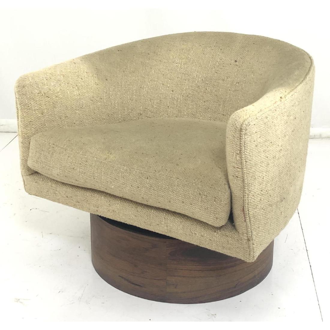 MILO BAUGHMAN Swivel Modernist Lounge Chair. Barr: MILO BAUGHMAN Swivel Modernist Lounge Chair. Barrel back chair in oatmeal tweed upholstery. Deep rosewood veneer platform base. Not marked.-- Dimensions: H: 24 inches: W: 27.5 inches: D: 29 inches ---