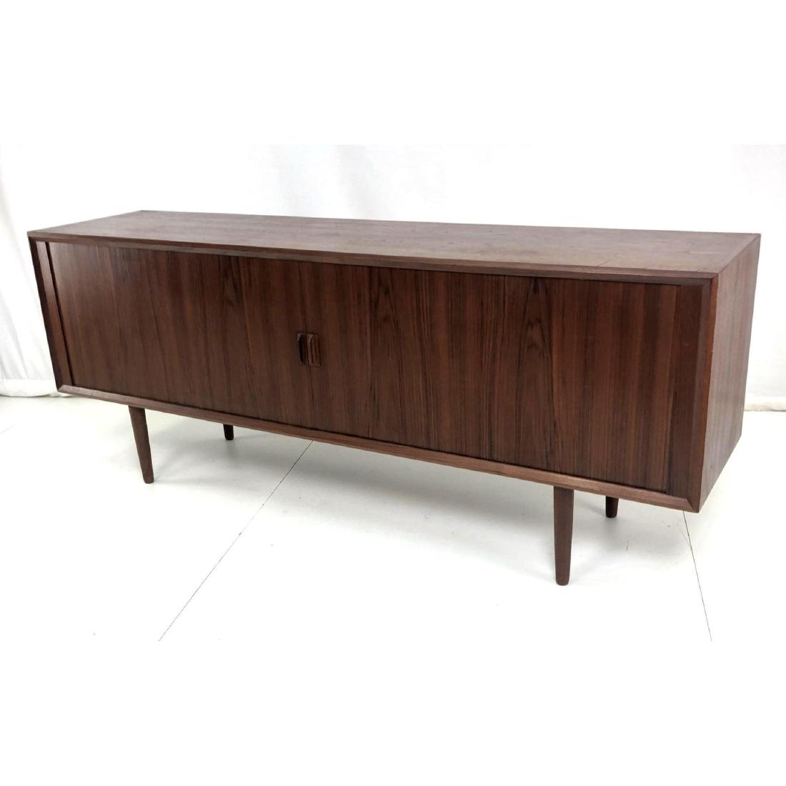 Danish Modern Teak Long Credenza Sideboard. Tambo: Danish Modern Teak Long Credenza Sideboard. Tambour doors with modernist wood pulls. Tapered legs. Finished on the back.-- Dimensions: H: 31.5 inches: W: 80 inches: D: 19 inches ---