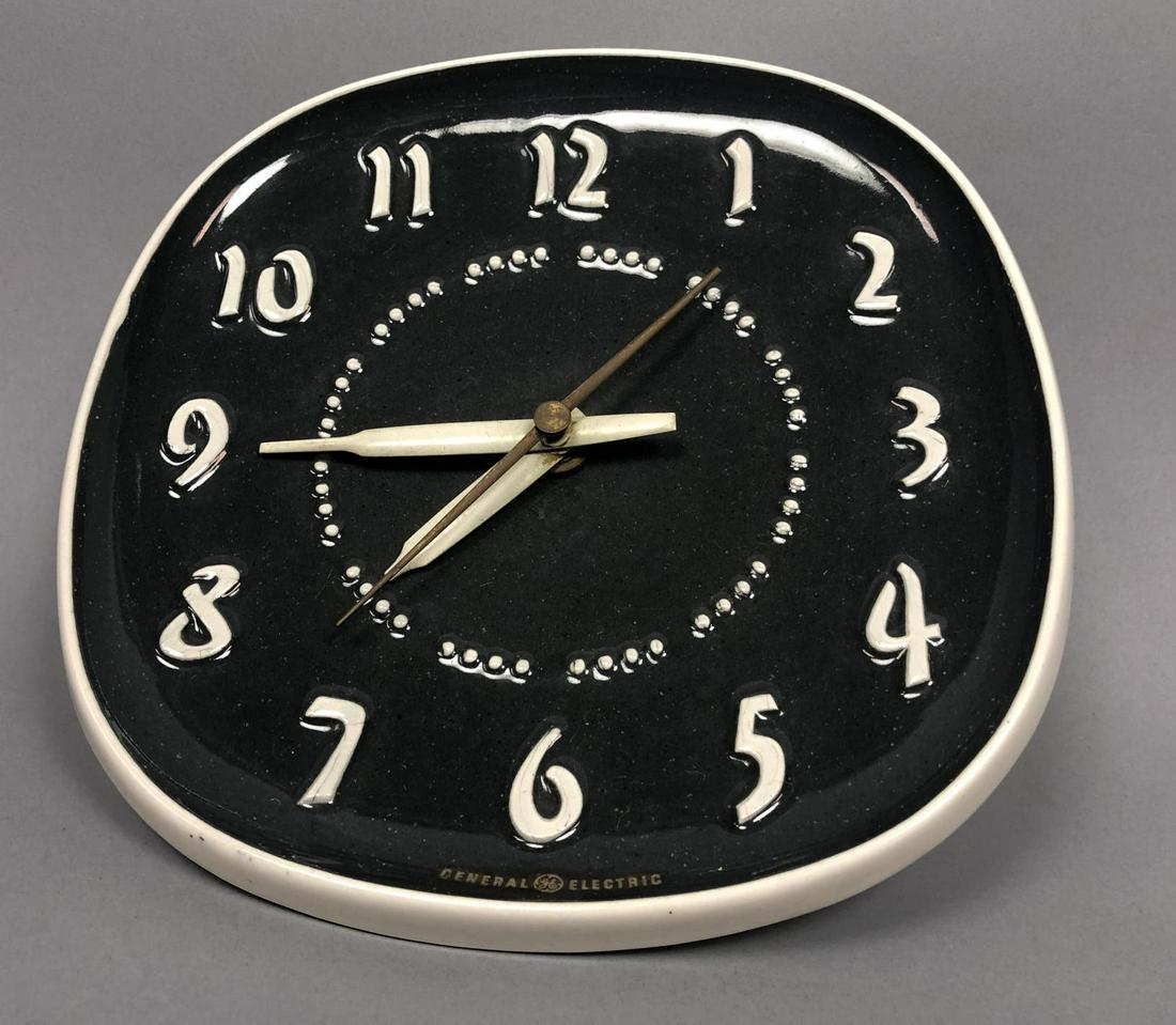 Mid Century RUSSEL WRIGHT for GE Wall Clock. Rais: Mid Century RUSSEL WRIGHT for GE Wall Clock. Raised number on black face.-- Dimensions: H: 8 inches: W: 8 inches: D: 3 inches ---