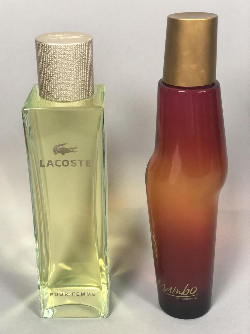 2 Oversized Perfume Display Bottles Lacoste pour: 2 Oversized Perfume Display Bottles Lacoste pour femme & Mambo by Liz Claiborne. Filled with colored water, not perfume.-- Dimensions: H: 15 inches: W: 3.5 inches: D: 3.5 inches ---