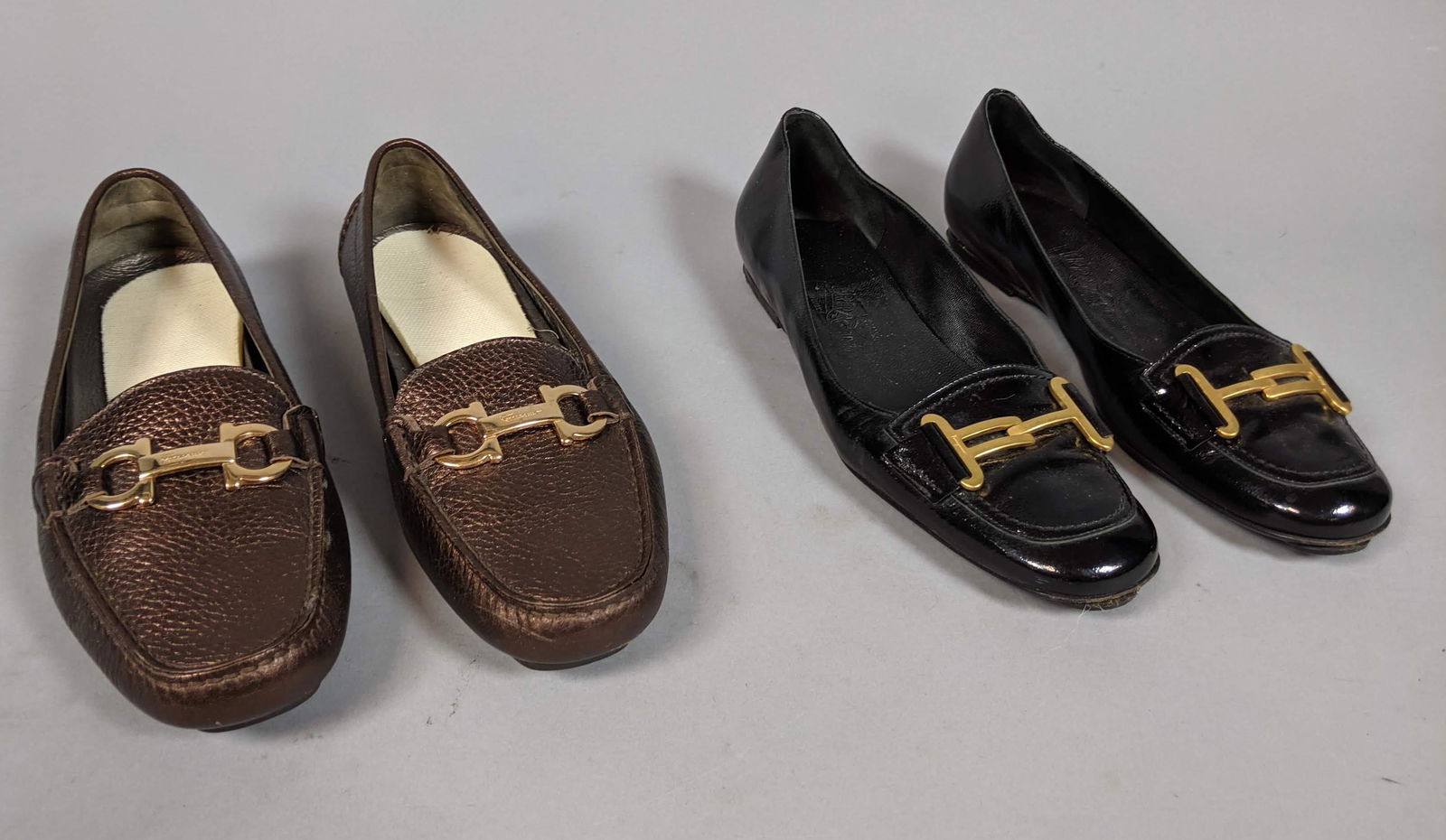 Two Pair SALVATORE FARREGAMO Driving Loafers Shoe: Two Pair SALVATORE FARREGAMO Driving Loafers Shoes. Ladies. 1.) Copper pebble leather driving shoes. Signature Ferragamo buckle. Size 7. Appear unworn. 2.) Black patent leather loafers. Matte gold buc