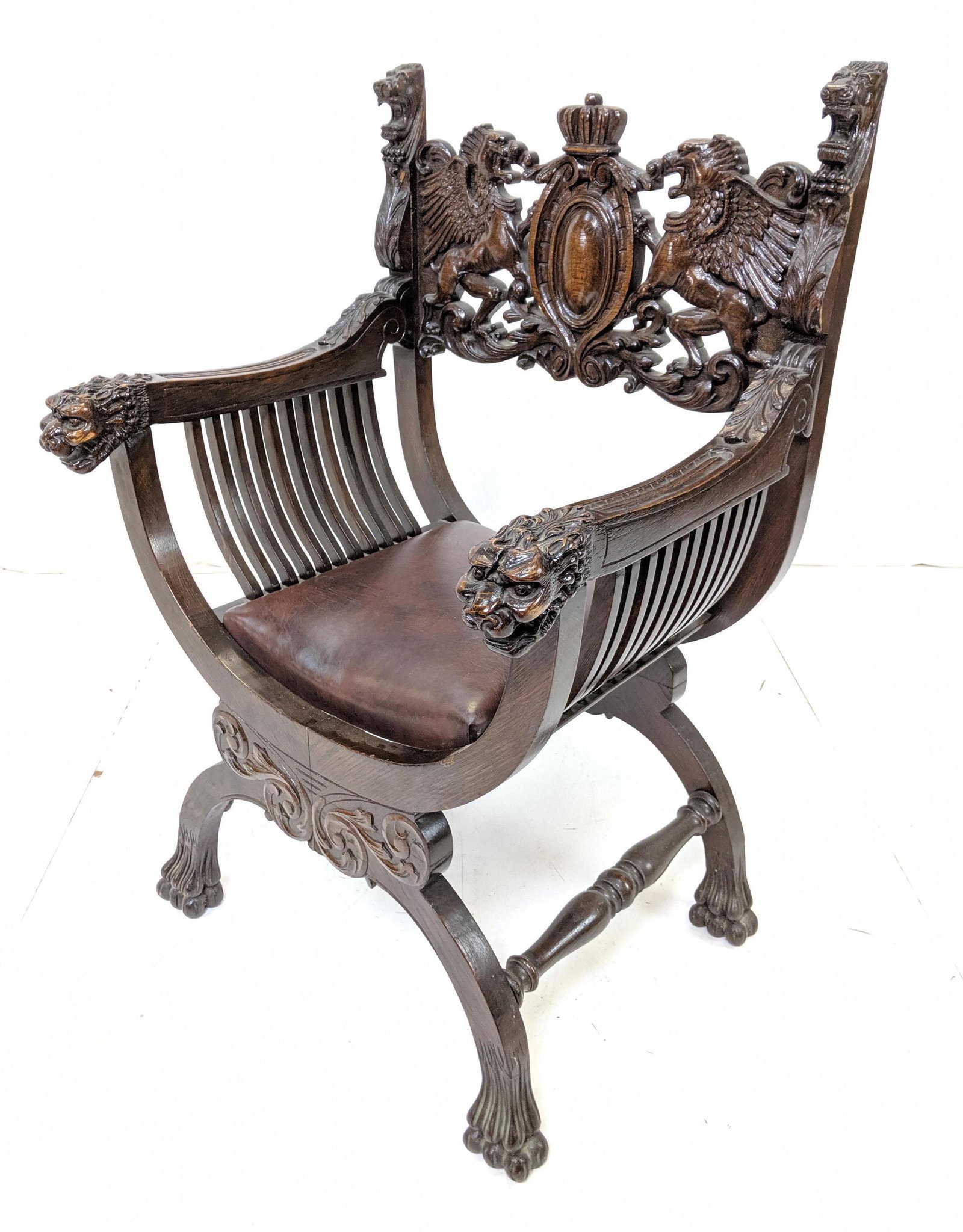 Oak Carved Chair with Griffin Head Arms & Paw Fee: Oak Carved Chair with Griffin Head Arms & Paw Feet. Griffins on back. Brown cushion. Heavily Carved.-- Dimensions: H: 41 inches: W: 27 inches: D: 22 inches --- 15.5 seat width.