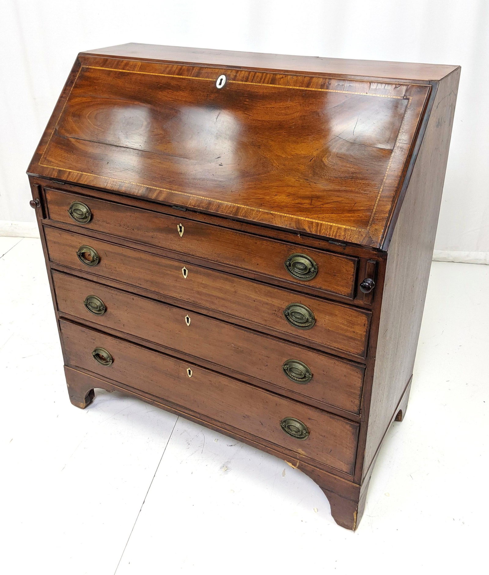 Antique Slant Lid Desk. Inlaid pattern. Metal pul: Antique Slant Lid Desk. Inlaid pattern. Metal pulls with bone key hole escutcheons. Damage to some brasses.-- Dimensions: H: 44 inches: W: 40 inches: D: 19.5 inches ---