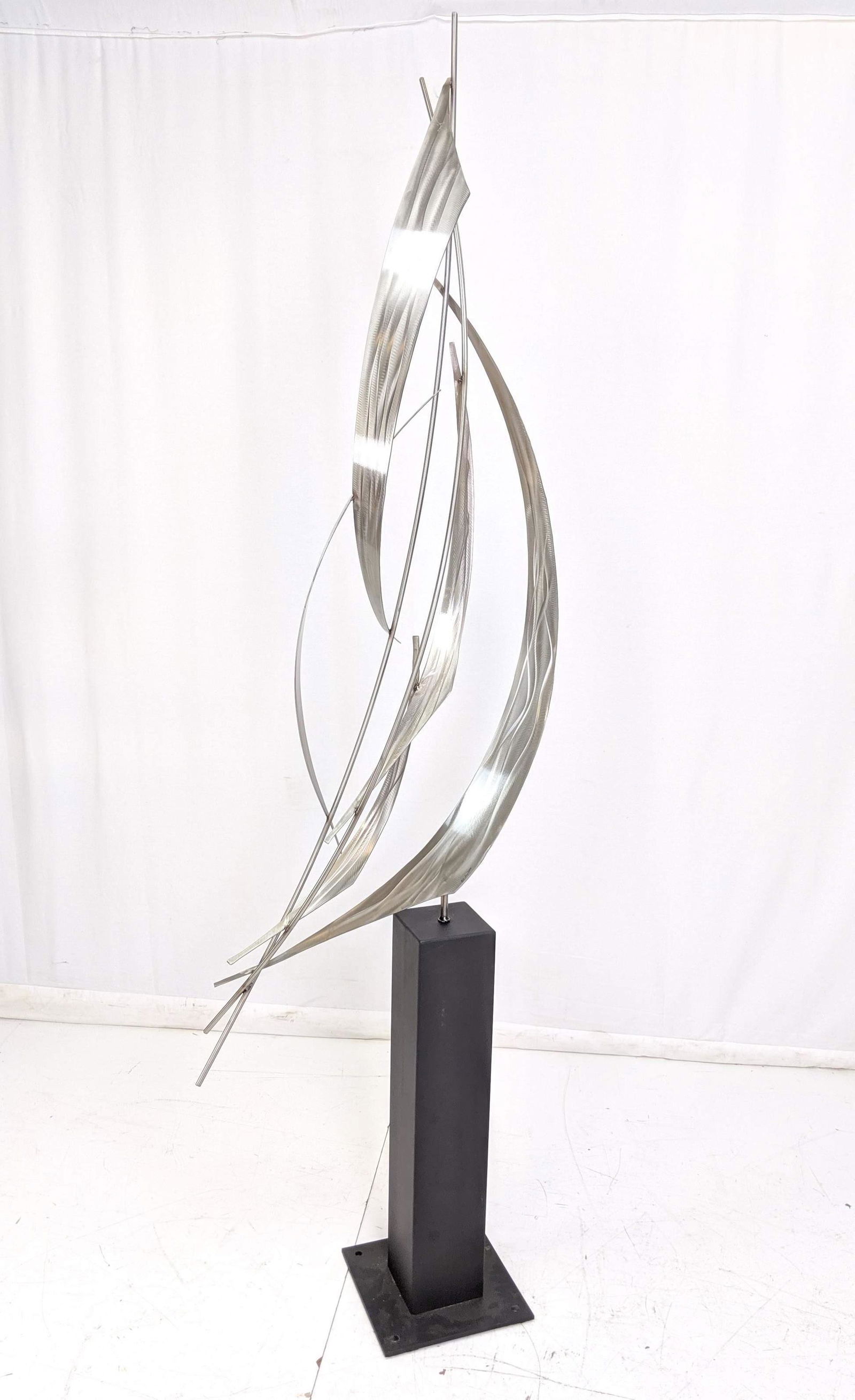 Signed C JERE Stainless "Sails" 91" Tall Sculptur: Signed C JERE Stainless "Sails" 91" Tall Sculpture. Pivots on square black metal base supports sweeping sculpture of engine turned sail ribbons. Signed C Jere 2004.-- Dimensions: H: 91 inches: W: 26 i