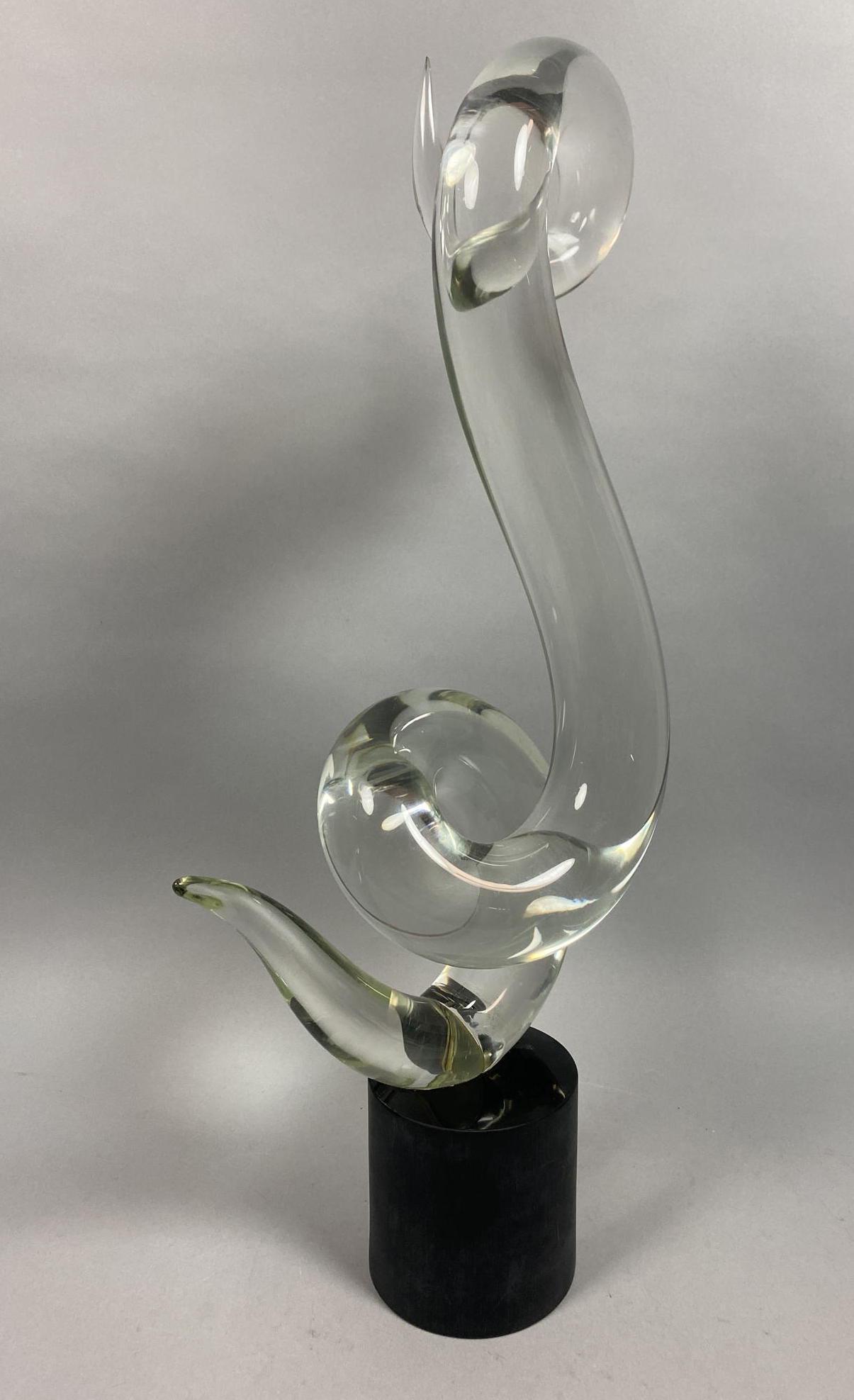 ELIO RAFFAELI Murano Art Glass Table Sculpture. T: ELIO RAFFAELI Murano Art Glass Table Sculpture. Twisted clear glass scroll form on black glass base. Signed on underside. -- Dimensions: H: 27 inches: W: 11 inches: D: 6 inches ---