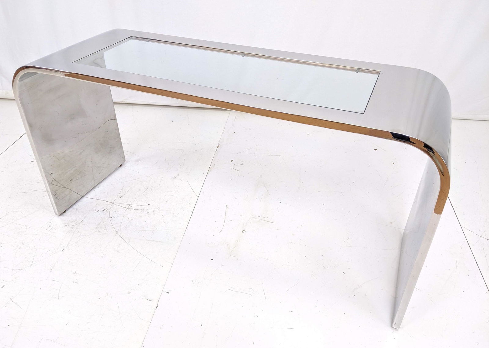 BRUETON Polished Stainless Steel Console Hall Table. Mo: BRUETON Polished Stainless Steel Console Hall Table. Modernist Streamline form with inset glass. Very Heavy.-- Dimensions: H: 29.5 inches: W: 59 inches: D: 20 inches ---